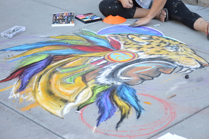 Dominique Montaño works on her art piece at the Sept. 24 Centennial Chalk Art Festival at The Streets at SouthGlenn.